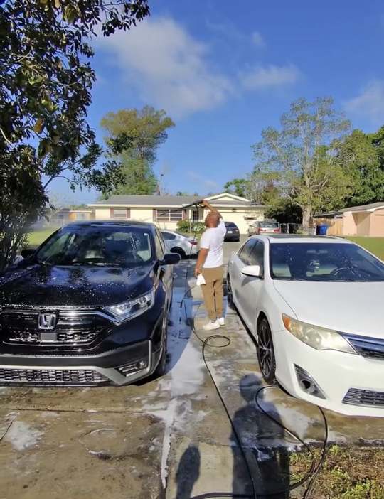 Bashir rinsing a black Honda SUV